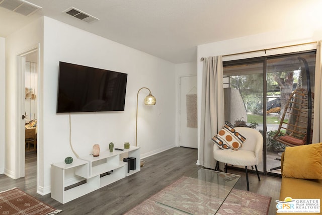 living room with dark hardwood / wood-style flooring