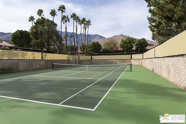 view of tennis court with a mountain view