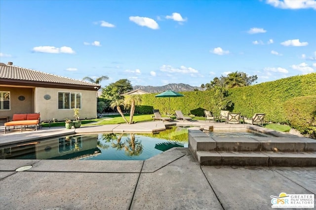 view of pool featuring a mountain view and a patio