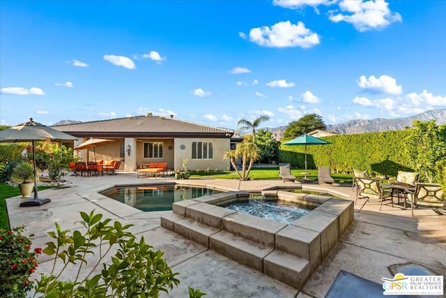 view of pool featuring a mountain view, a patio area, an outdoor hangout area, and an in ground hot tub