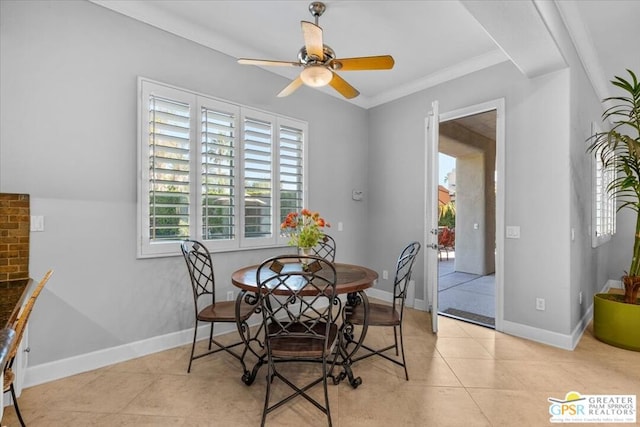 dining room with ceiling fan, crown molding, and light tile patterned flooring