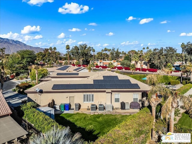 rear view of property with a mountain view, a patio, and central AC unit