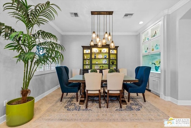 dining space with a notable chandelier, light tile patterned floors, and crown molding