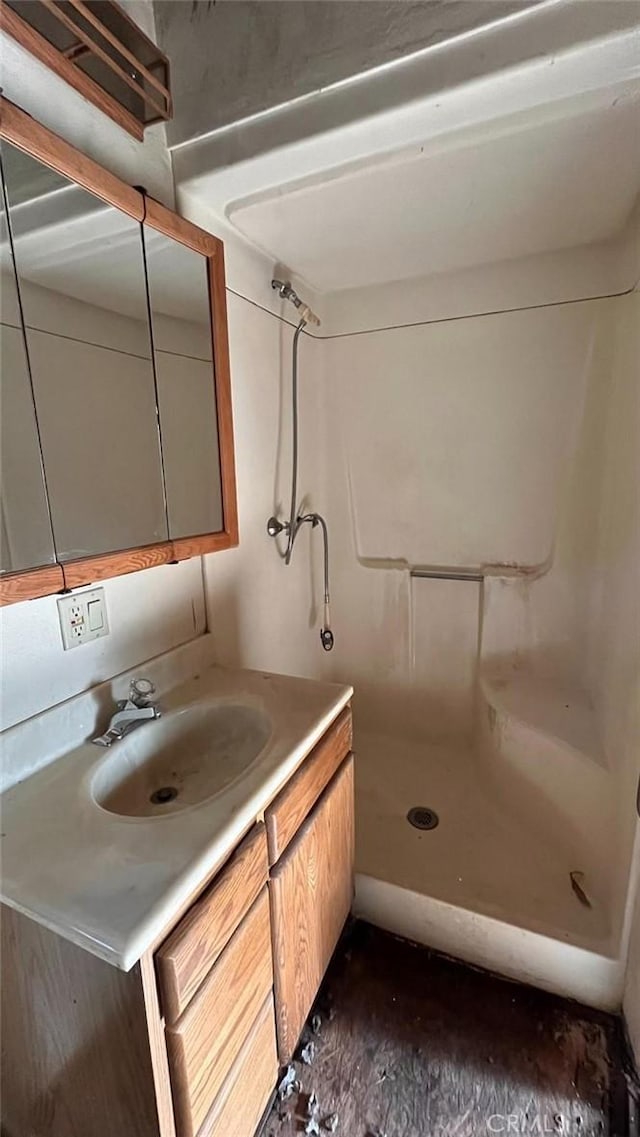 bathroom with vanity and a shower