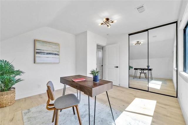 office featuring light hardwood / wood-style floors and lofted ceiling