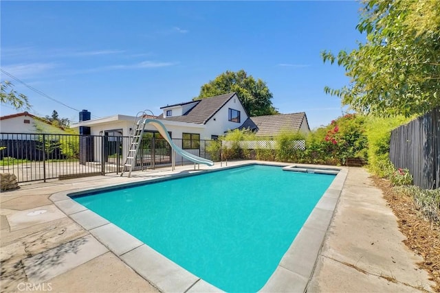 view of pool with a patio area and a water slide