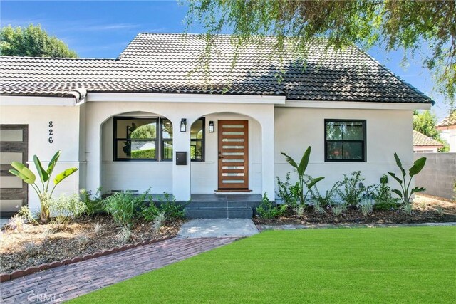 mediterranean / spanish-style house with a front lawn