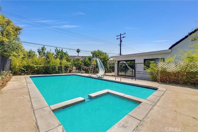 view of swimming pool featuring a water slide and a patio