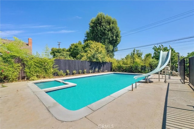 view of swimming pool with a patio area and a water slide