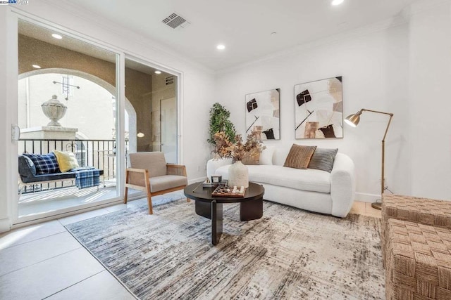 sitting room featuring tile patterned flooring and ornamental molding