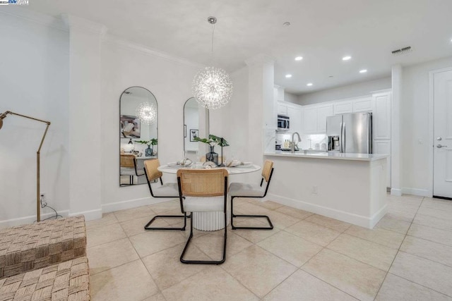 dining room featuring ornamental molding, light tile patterned floors, and an inviting chandelier