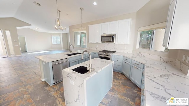 kitchen featuring sink, hanging light fixtures, a kitchen island, stainless steel appliances, and light stone countertops