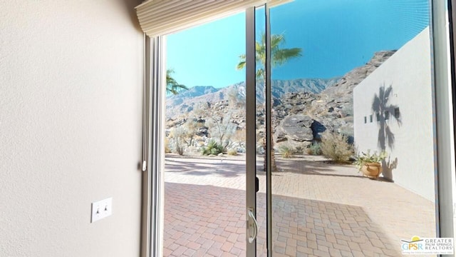 doorway to outside featuring a mountain view