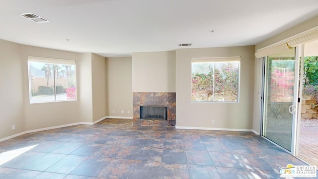 unfurnished living room with a tile fireplace