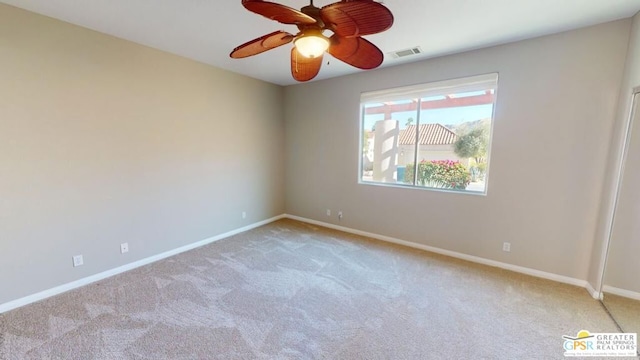 carpeted empty room featuring ceiling fan