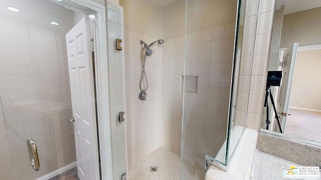 bathroom with a shower with shower door