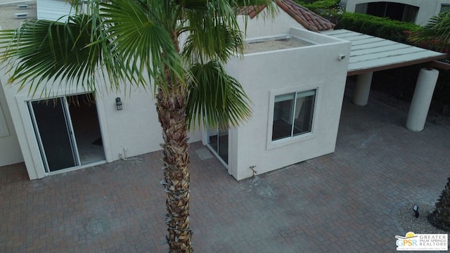 view of side of home with a patio area