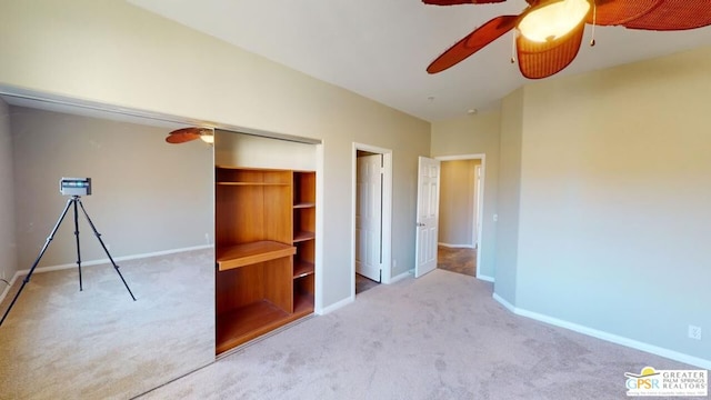 unfurnished bedroom with ceiling fan, light colored carpet, and a closet