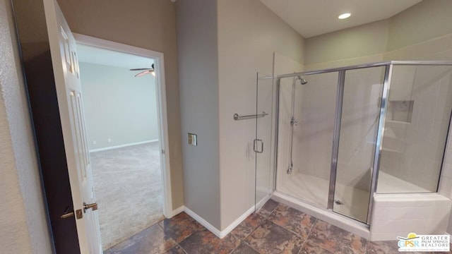 bathroom featuring a shower with shower door and ceiling fan