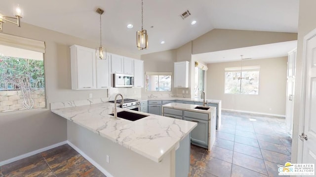 kitchen with kitchen peninsula, hanging light fixtures, and white cabinets