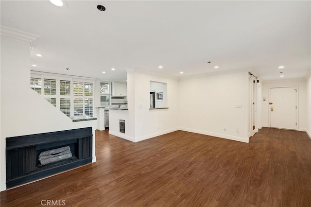 unfurnished living room with crown molding and dark hardwood / wood-style floors