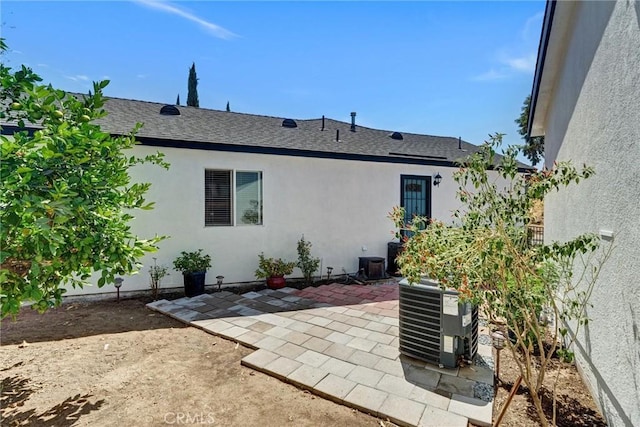 rear view of house with a patio and cooling unit