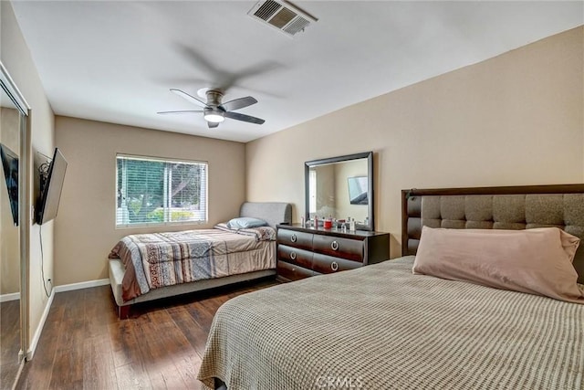 bedroom with ceiling fan and dark wood-type flooring