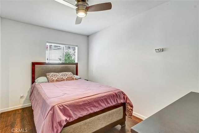 bedroom featuring ceiling fan and dark hardwood / wood-style flooring