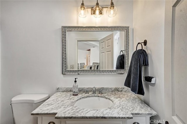 bathroom with vanity and toilet