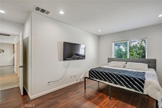 bedroom with dark wood-type flooring