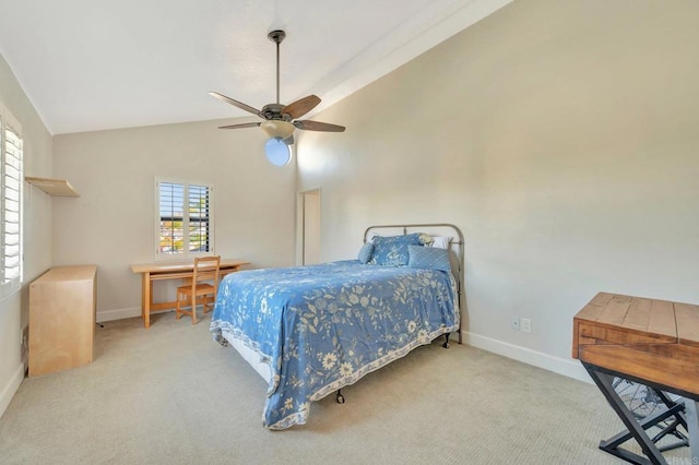 carpeted bedroom with ceiling fan and high vaulted ceiling