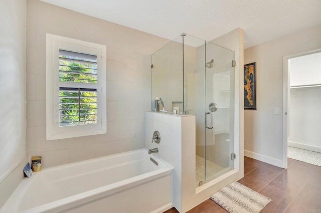 bathroom with separate shower and tub and tile patterned floors