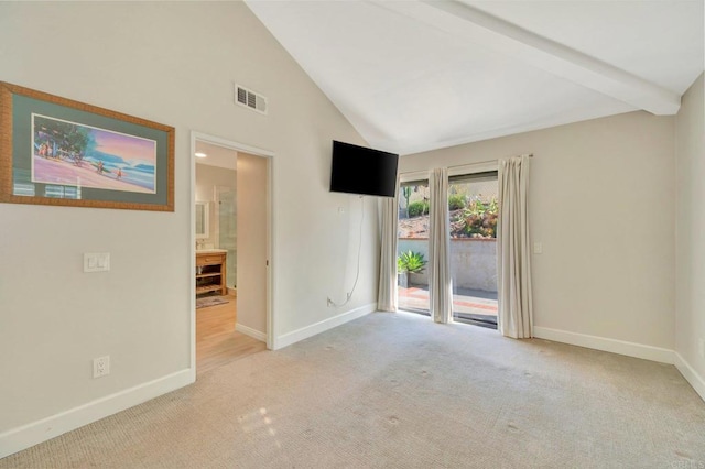 carpeted empty room with beamed ceiling and high vaulted ceiling