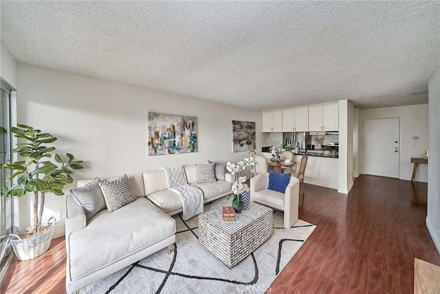 living room with hardwood / wood-style floors and a textured ceiling