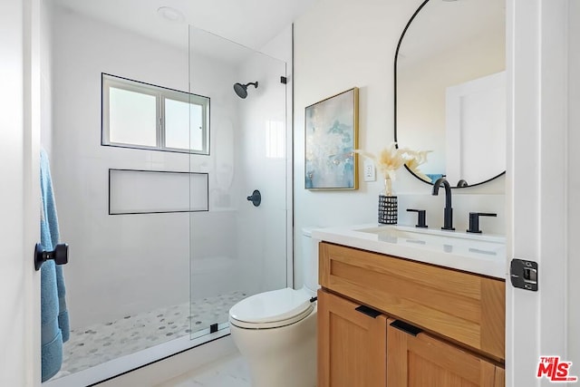 bathroom featuring vanity, toilet, and an enclosed shower