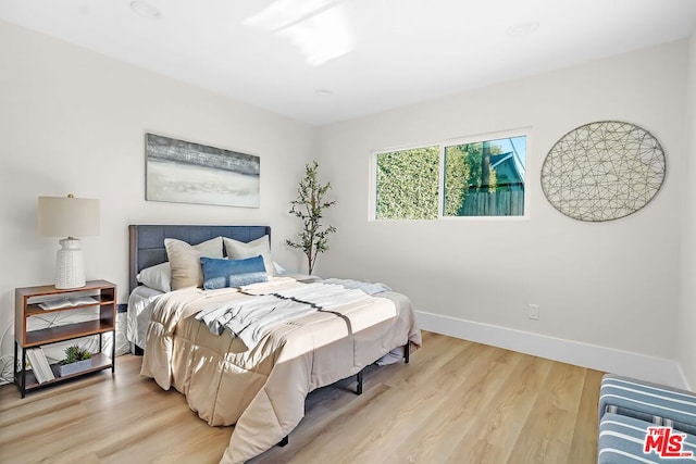 bedroom with light wood-type flooring