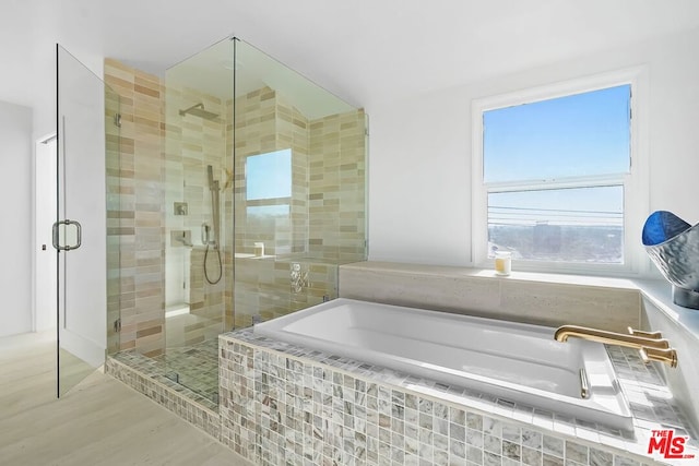 bathroom featuring hardwood / wood-style floors and shower with separate bathtub