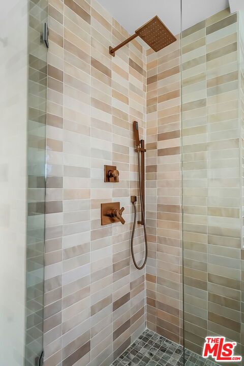 bathroom with tiled shower