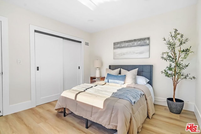 bedroom featuring a closet and light wood-type flooring