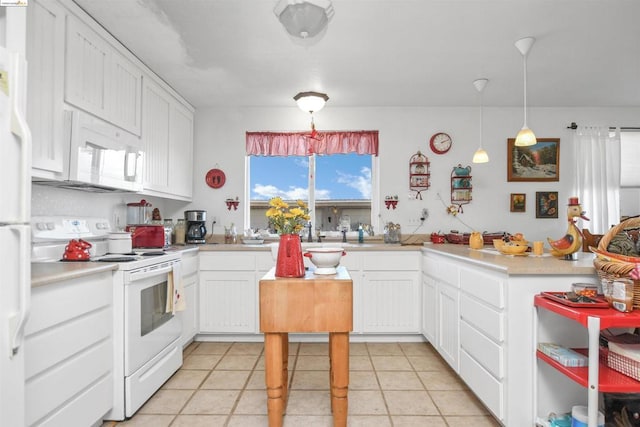 kitchen with white appliances, white cabinets, sink, hanging light fixtures, and light tile patterned floors