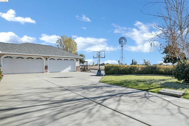 view of side of property with a lawn and a garage