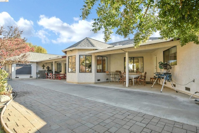 back of property with a patio