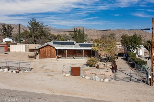 ranch-style home featuring a mountain view and an outbuilding