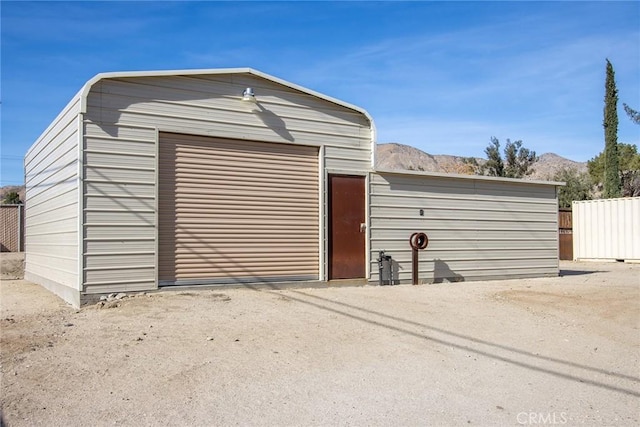 view of outdoor structure with a mountain view and a garage