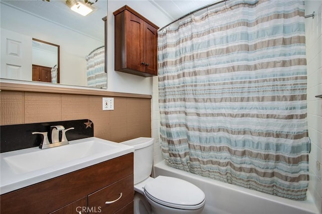 full bathroom with vanity, tile walls, shower / tub combo, and toilet