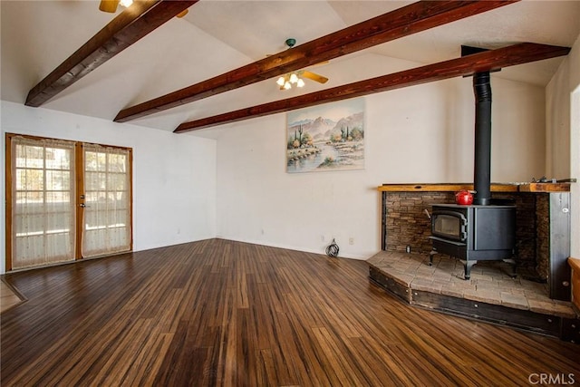 unfurnished living room with a wood stove, vaulted ceiling with beams, hardwood / wood-style flooring, ceiling fan, and french doors