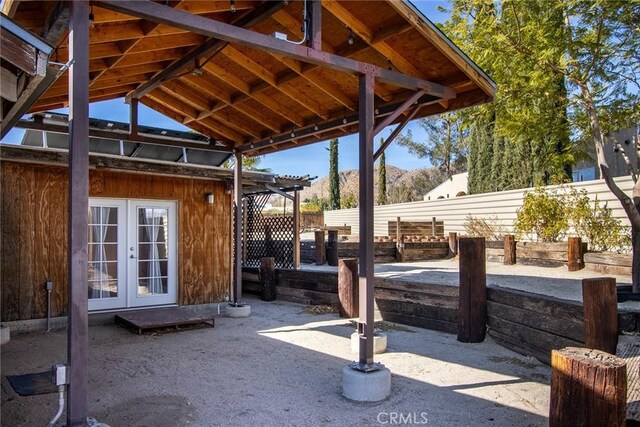 view of patio with a mountain view and french doors