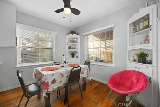 dining space featuring ceiling fan and dark hardwood / wood-style floors