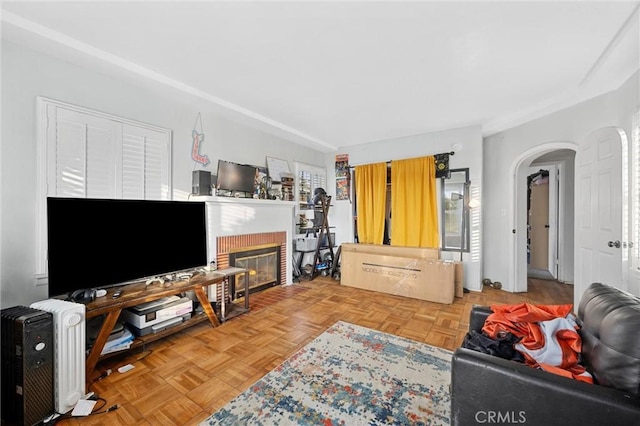 living room with parquet floors and a brick fireplace