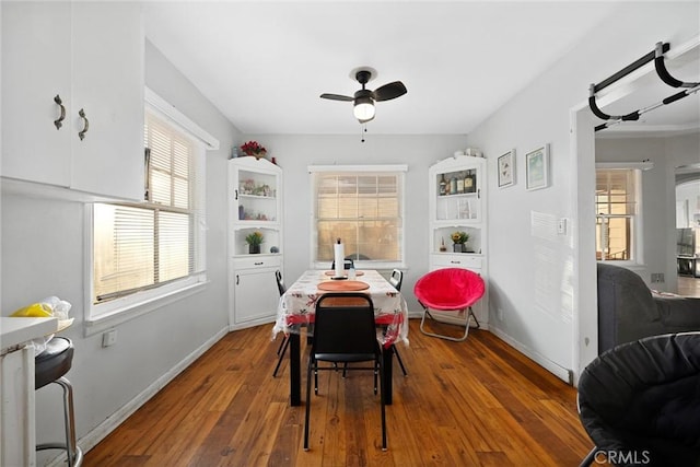 dining area with ceiling fan and dark hardwood / wood-style floors